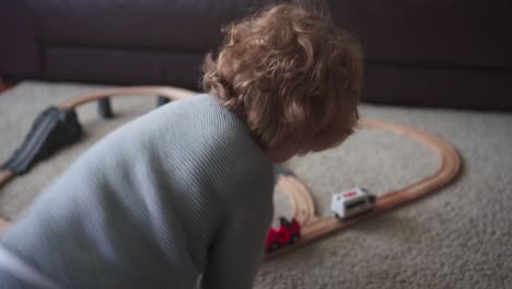 Little-boy-playing-with-toy-track