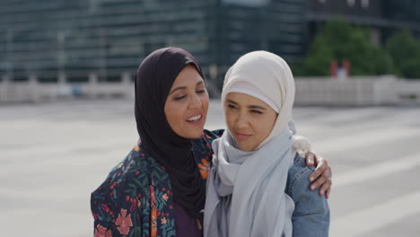 portrait-beautiful-muslim-mother-hugging-sad-daughter-embracing-in-city-wearing-hijab-headscarf-slow-motion