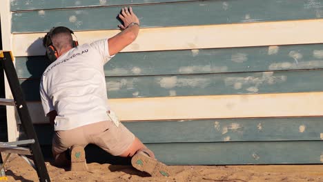 worker repairing beach house wall