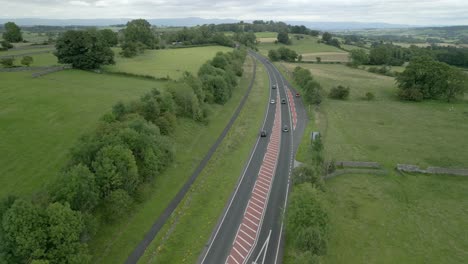 Busy-rural-road-A66-cutting-through-green-summer-landscape