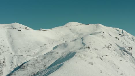 ski lift ascending up snow-covered mountaintops slopes