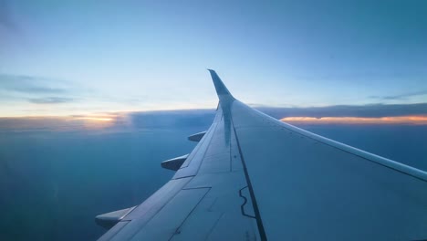 Airplane-Wing,-Clouds,-And-Sky-Seen-From-Window-During-The-Flight---static,-POV