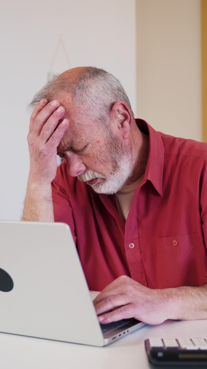 Stressed Senior Man Struggling with Laptop