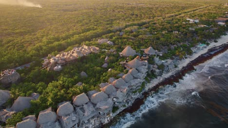 aerial view of the azulik hotel in the beaches of tulum, méxico during sunset