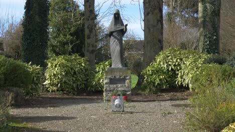 wooden statue our lady of trim - maudlin cemetery yard in trim, ireland