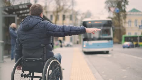 person with a physical disability stops public transport with an accessible ramp