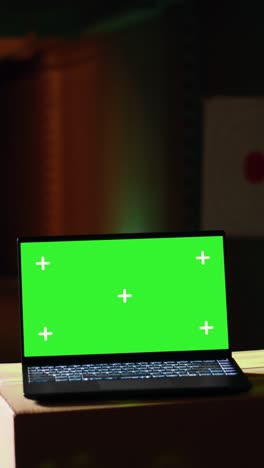 vertical video green screen laptop in shooting range next to man successfully shooting targets