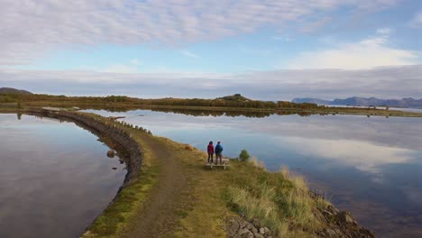 walking along a scenic path by a calm lake in vestarelen, norway on a peaceful day