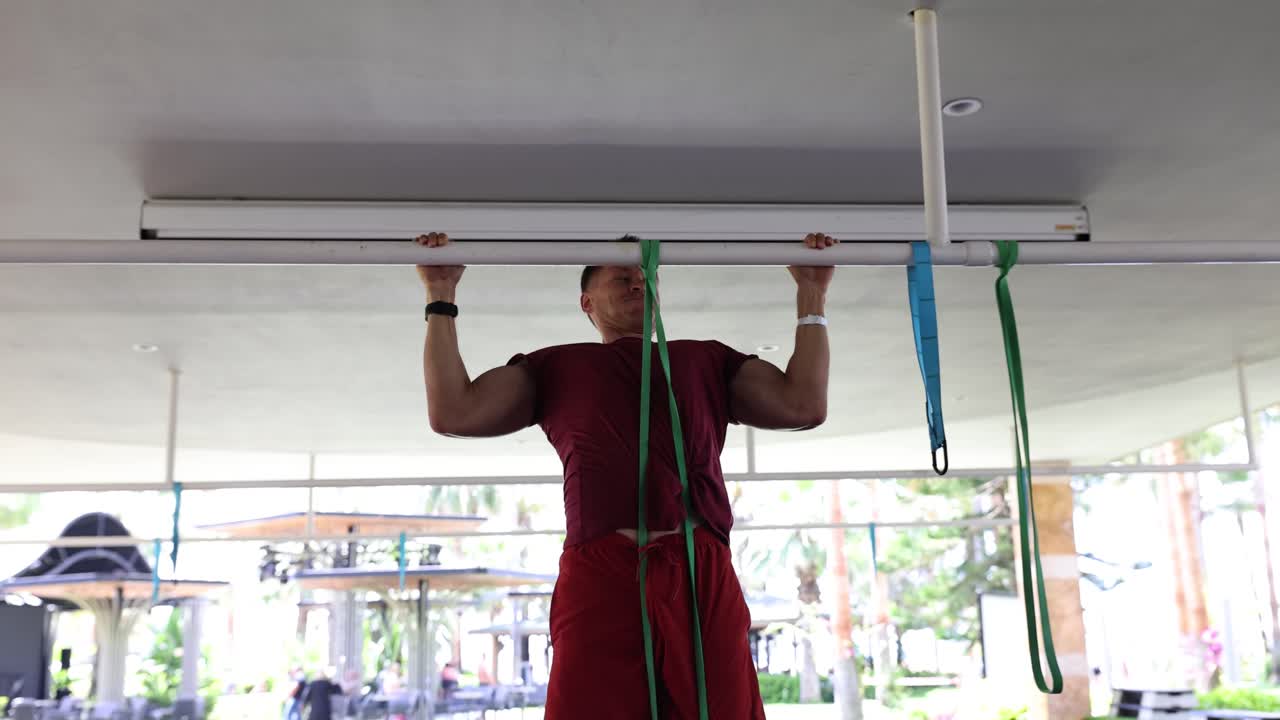 Man Doing Pull-Ups with Resistance Bands