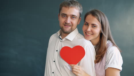 couple holding a red heart
