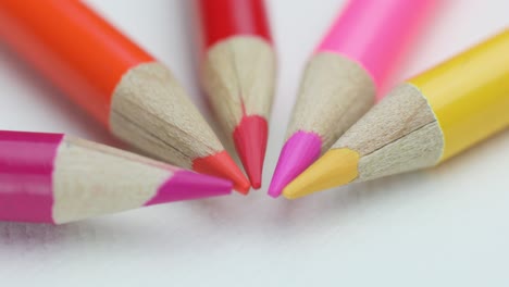 Close-up-Of-Wooden-Colorful-Sharp-Tips-Arranged-Semicircularly-In-White-Surface