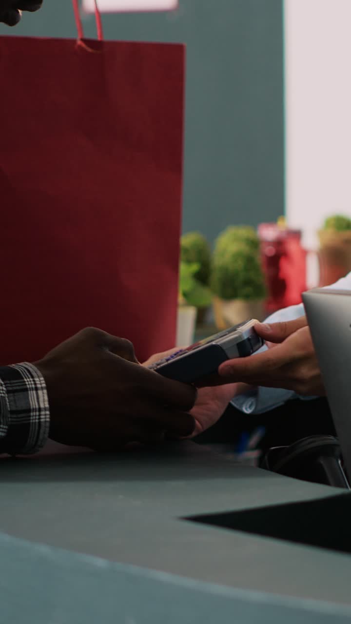 People using a terminal to pay for shopping