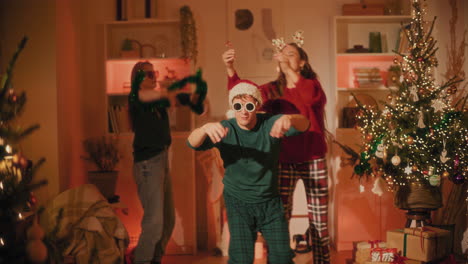 man enjoys dancing with female friends at home