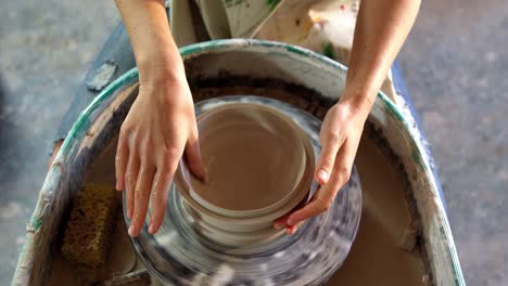 hands of female potter making a pot