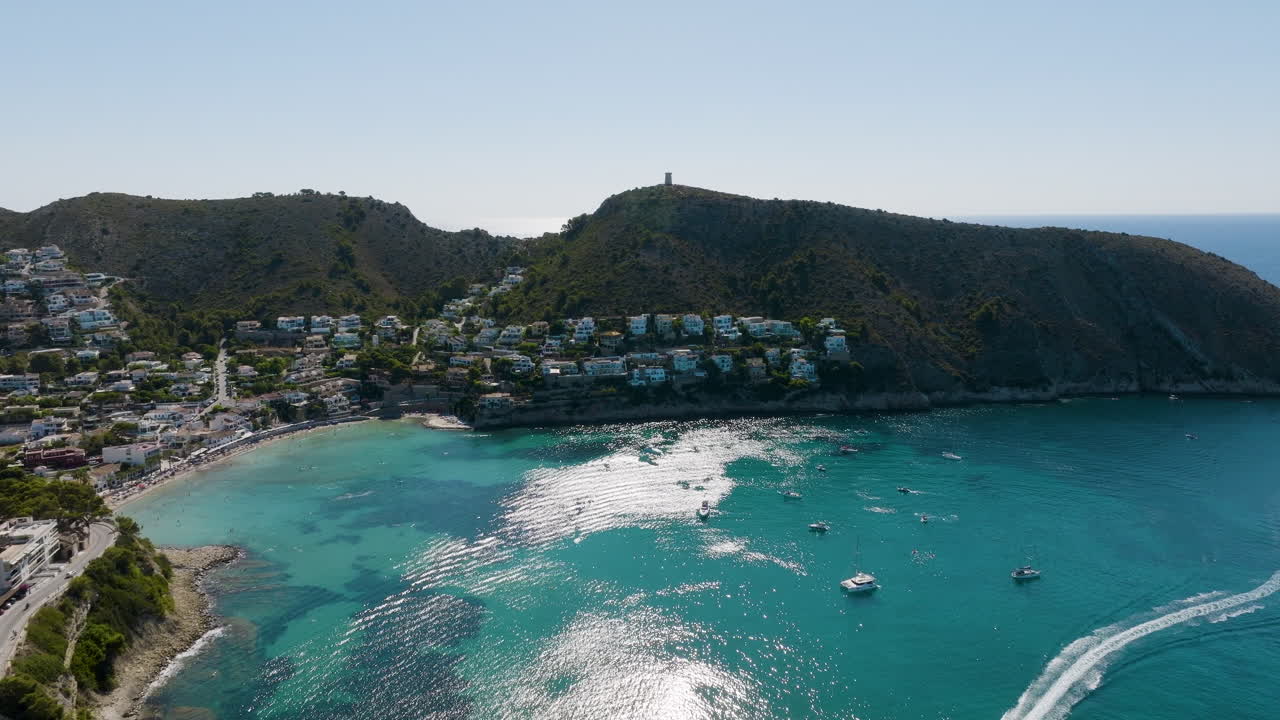 Coastal town with turquoise waters and mountains