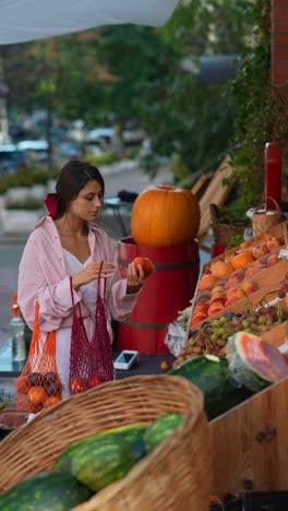 woman shopping for fruits at a farmers market