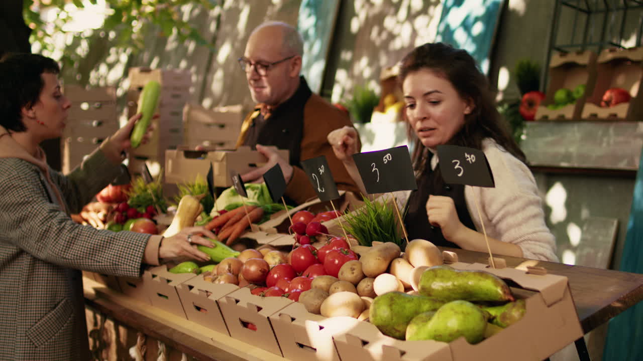People buying produce at a farmers market