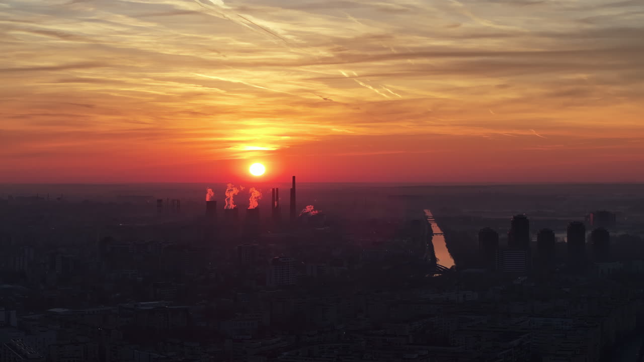 Aerial drone view of thermal power stations in Bucharest at sunset. Red sun. Romania