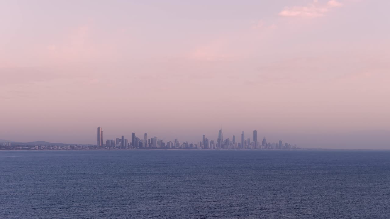 Panoramic Sunset View Of Surfers Paradise Skyline Across The Water In Gold Coast, Queensland. wide drone shot