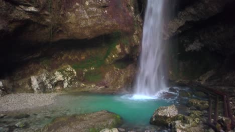 cave waterfall with turquoise pool