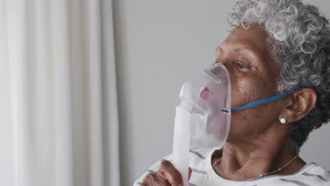 mujer afroamericana anciana con máscara de oxígeno, espacio de copia, cámara lenta
