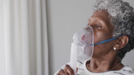 senior african american woman with oxygen mask, copy space, slow motion