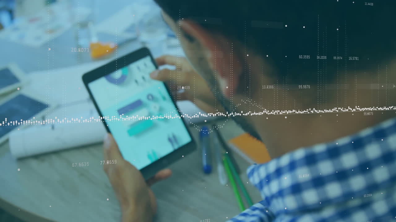 Using tablet, man viewing data processing animation overlay on screen