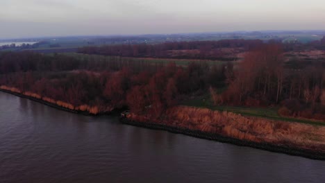 Aerial-View-Of-Fall-Trees-Beside-Oude-Maas-In-Puttershoek