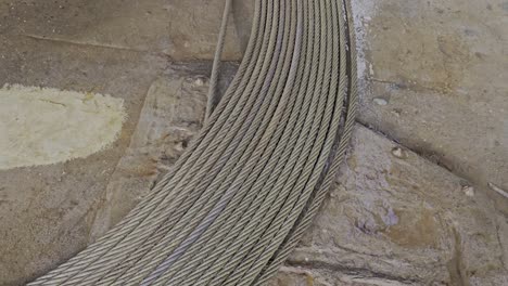 anchor wire coiled in circles in drydock, ready for inspection. close up transitions to full view