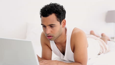 Attractive-calm-man-using-laptop