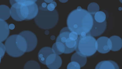 partículas redondas azules voladoras con brillos en degradado negro de moda