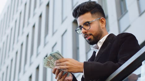 happy rich businessman wasting throwing money dollars cash around share, celebrate, charity donation