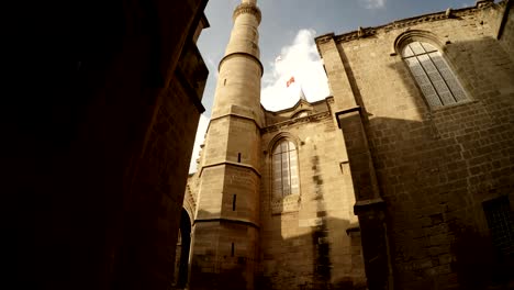 minaret of selimiye mosque flags of northern cyprus and turkey view down up