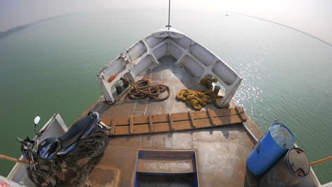 bow of a boat overlooking a river in bangladesh. this is a common way of transportation in bangladesh.
