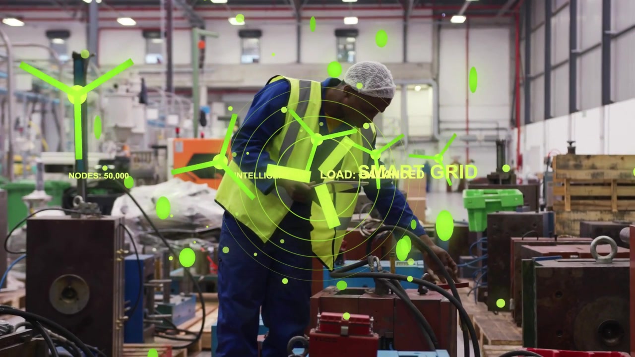 Consultando un tablet, un tecnico che regola i tubi in un impianto indossando un gilet ad alta visibilità e una tuta da lavoro con SMART GRID