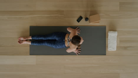 above view yoga woman practicing cobra pose in workout studio enjoying healthy lifestyle meditation practice training on exercise mat