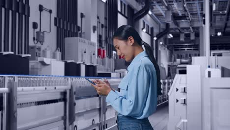 side view of asian female with her smartphone with water production in bottling factory, checking with dissapionted and nodding her shead