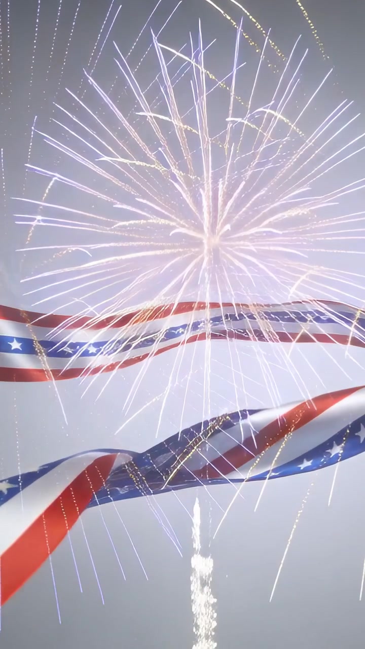 Video verticale: Ripresa in allontanamento che mostra un nastro a bandiera sventolare in uno studio grigio, fuochi d'artificio che vengono lanciati per celebrare.