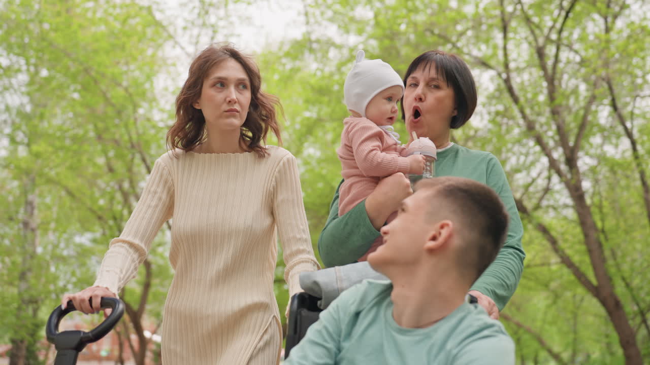 Mother And Caregiver Explore Lush Park Together, Family Cherishing Meaningful Moments Amidst Vibrant City Greenery, Enjoying Quality Leisure Time Outdoors With Loved Ones In Scenic Park Environment