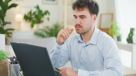 Pensive-Man-Working-Remotely-on-Laptop