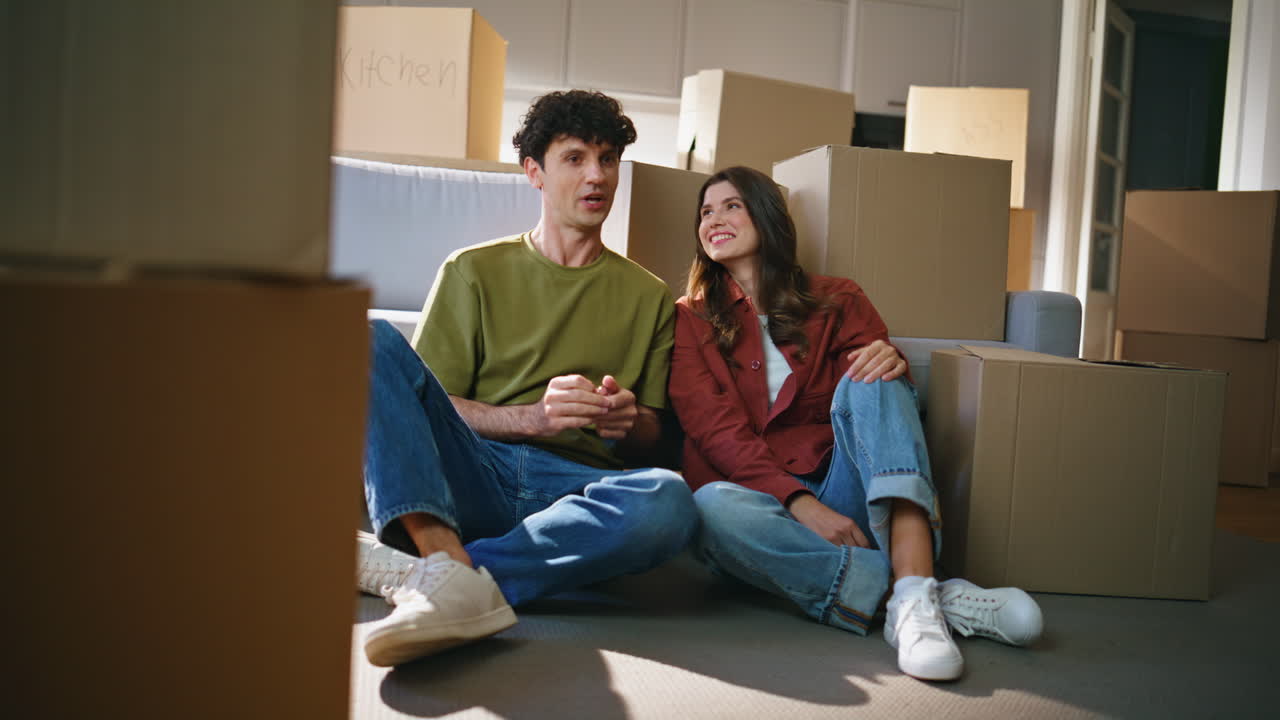 Property owners pair inspecting living room after moving relocation at new house