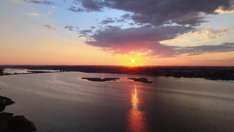 golden shadows play out across the shimmering morning waters of moses lake washington, aerial