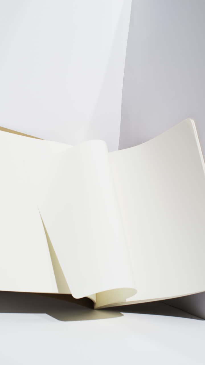 Video of books with white blank pages with copy space on white background