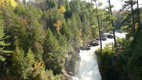 Powerful-waterfall-coming-down-massive-rocky-pathway-in-impressive-geology