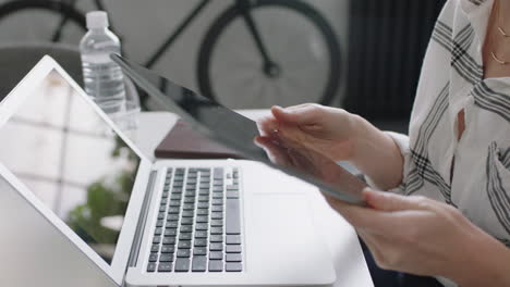 professional business woman using tablet computer presenting marketing strategy sharing ideas talking to client showing development plan on mobile technology in office meeting close up hands