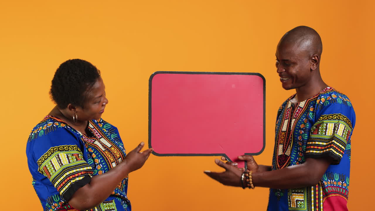 Married ethnic people pointing at red speech bubble icon