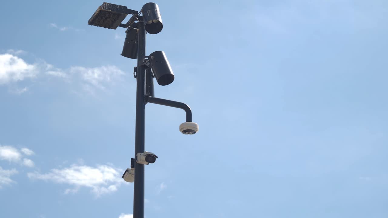 Security cameras and streetlight on a pole
