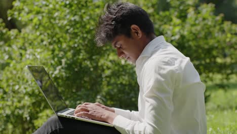 indian entrepreneur working remotely from park with laptop