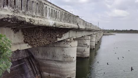 A-slow-motion-shot-of-a-bridge-on-the-river-stream-to-facilitate-road-connectivity-between-two-sides