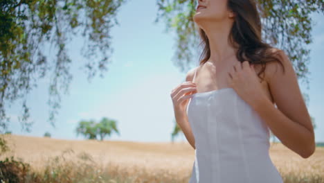 carefree model walking spikelets field back view. dress woman strolling summer